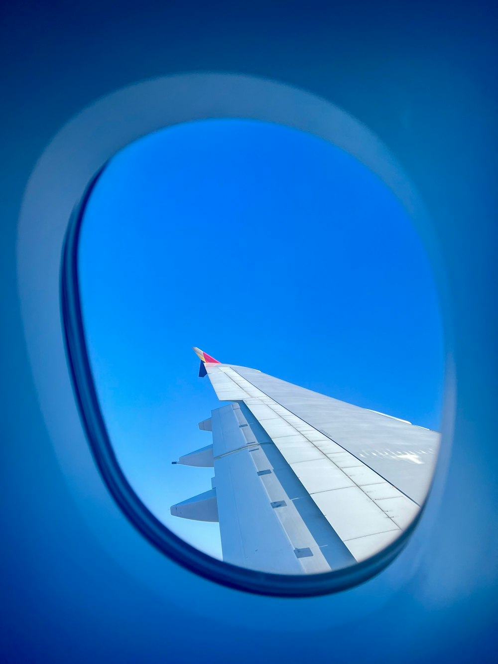 a view of the wing of an airplane through a window