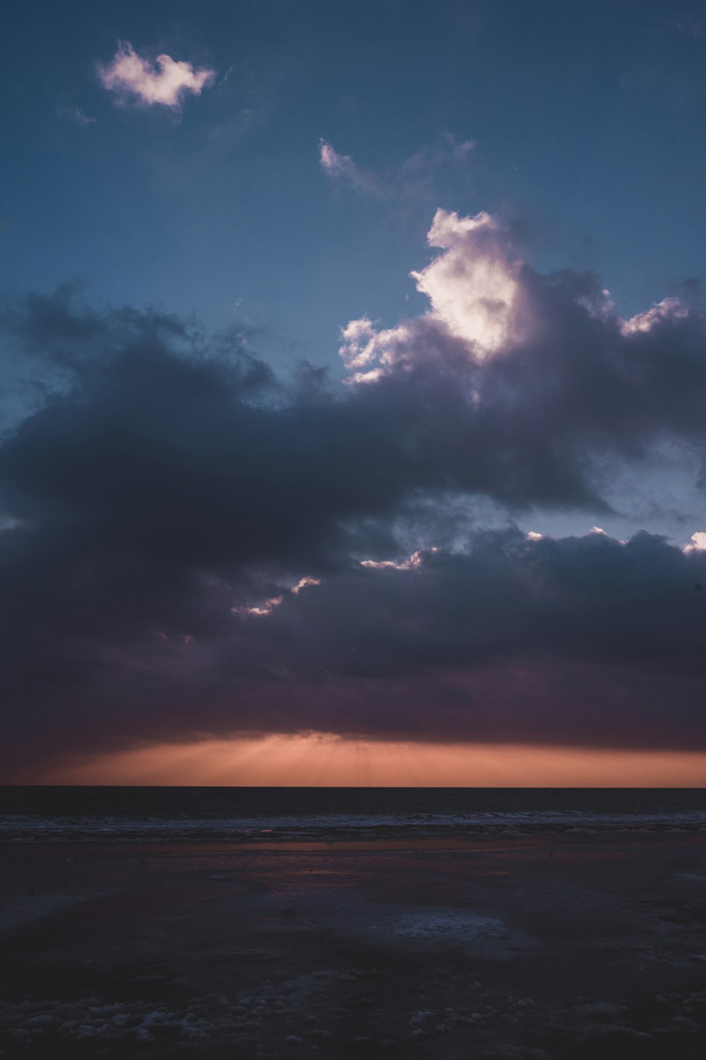 a large body of water under a cloudy sky