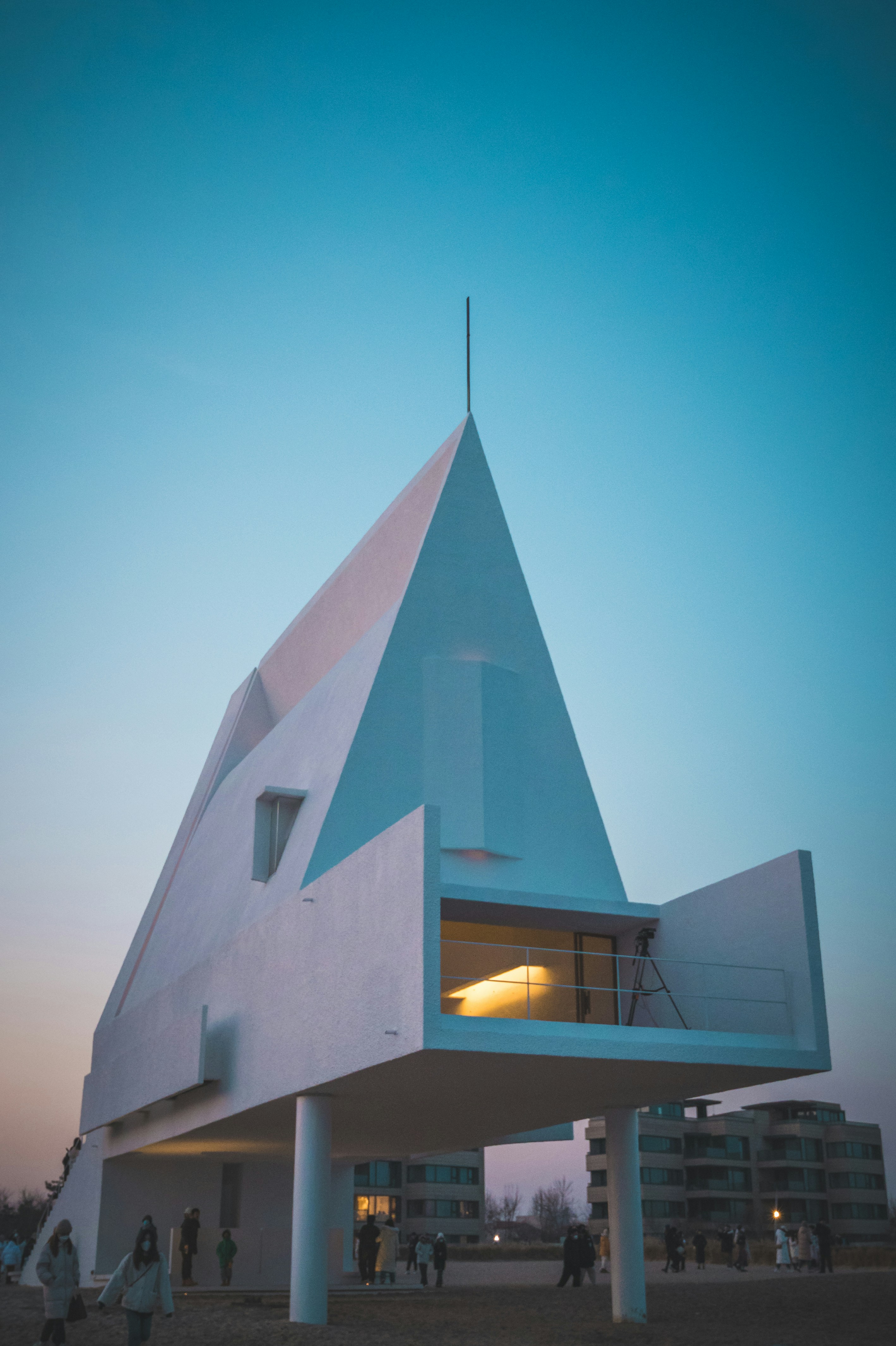 a large white building with a triangular roof