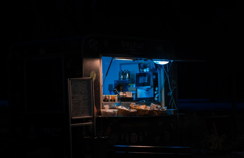 a food cart at night with food in it
