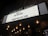 An illuminated theater marquee displays event information for an upcoming performance by Blu DeTiger on November 17 at August Hall. Surrounding the marquee are a series of lit bulbs, creating a warm, inviting atmosphere.