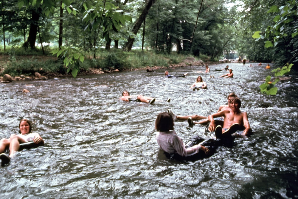 a group of people swimming in a river