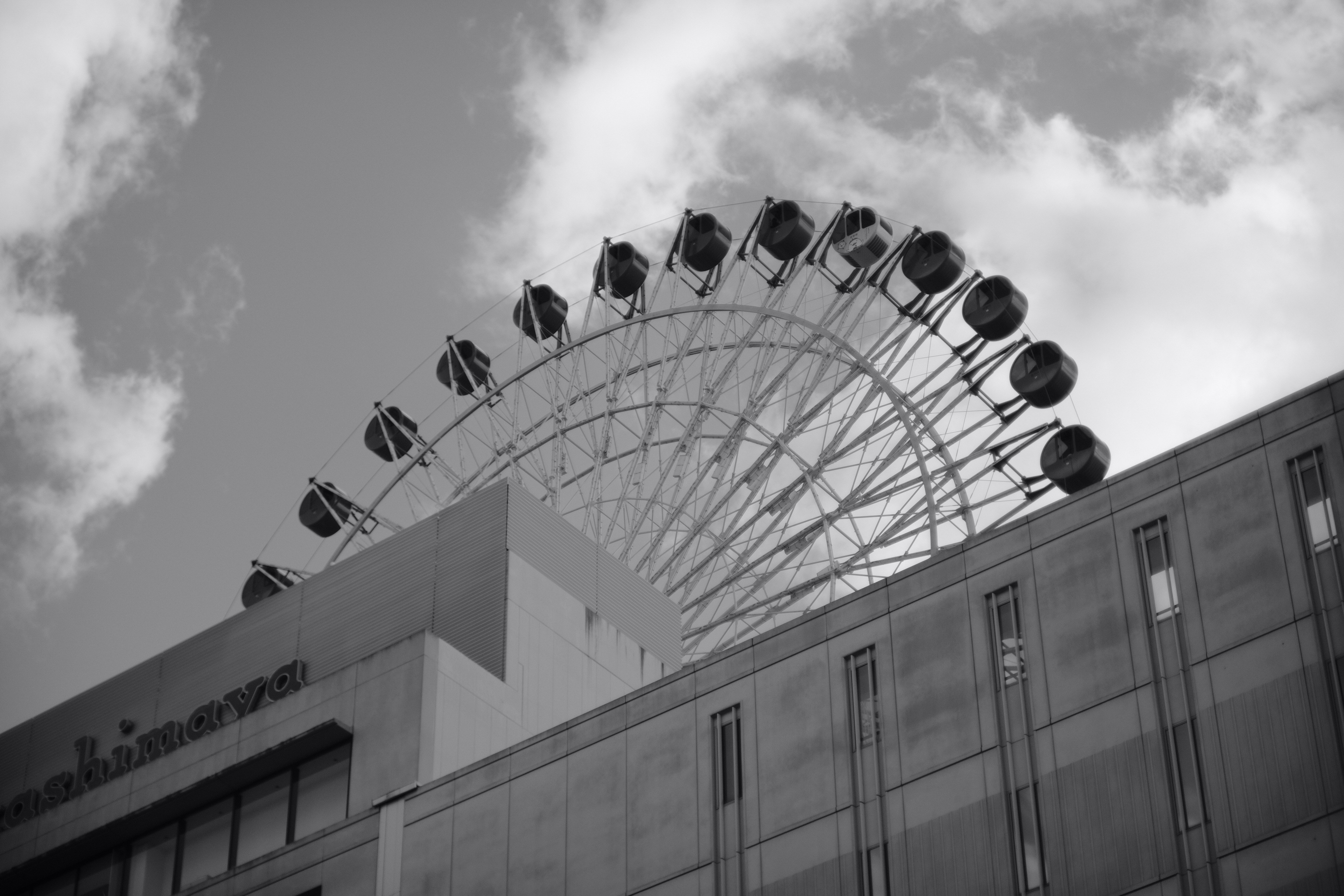 A large ferris wheel on top of a building photo – Free Building Image ...