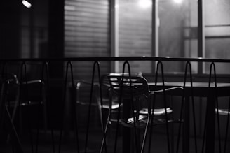 A softly lit, minimalist lounge space with empty chairs arranged quietly, evoking calm and discretion.