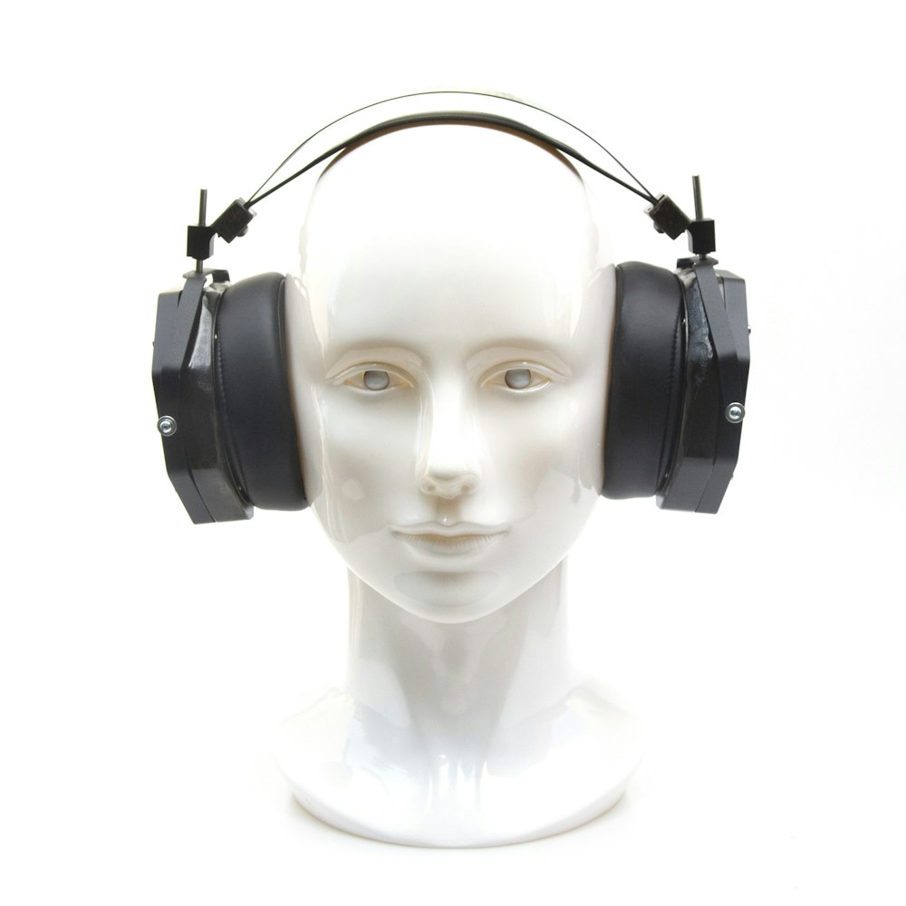 a white mannequin head with headphones on it