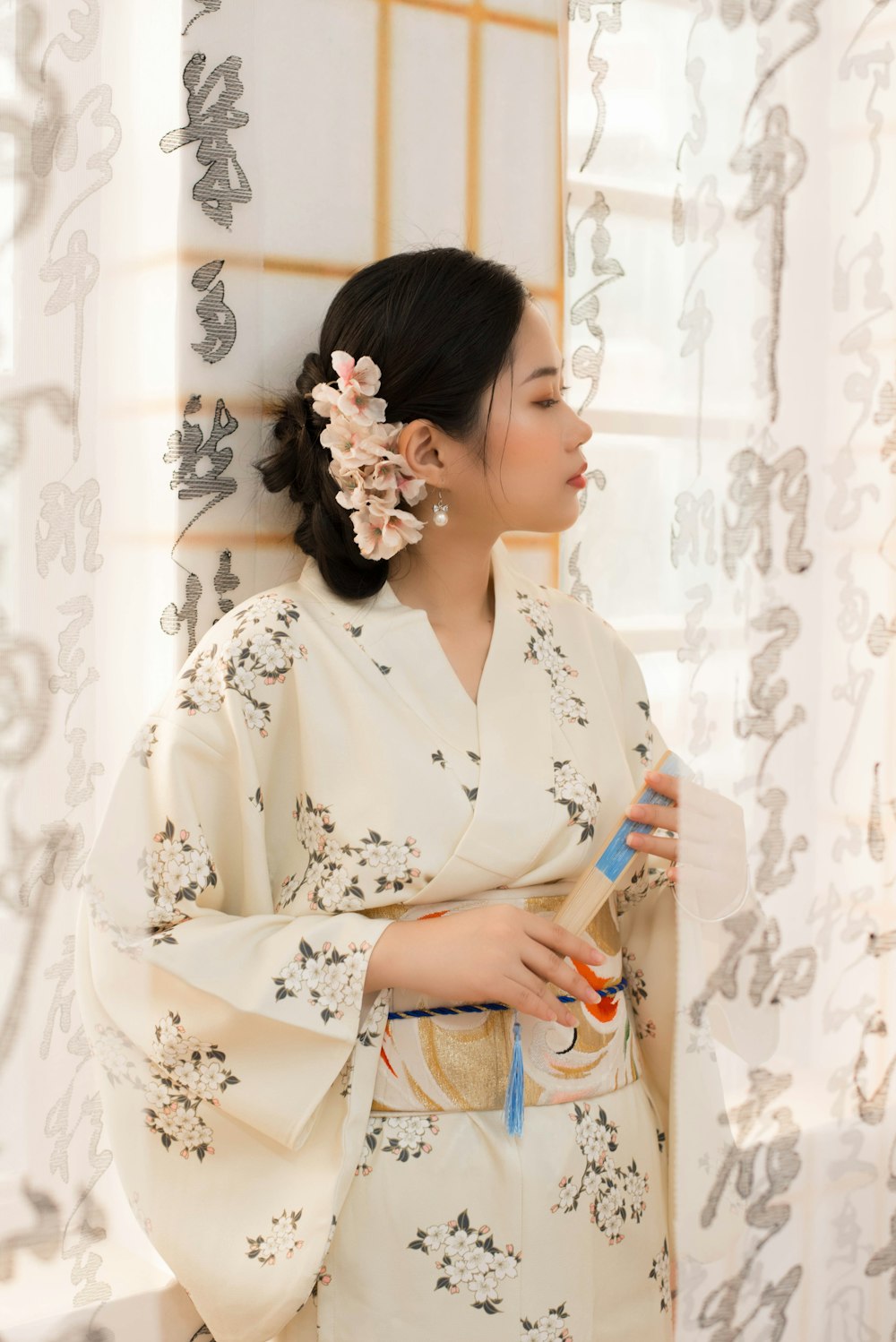 a woman in a kimono holding a bottle of water