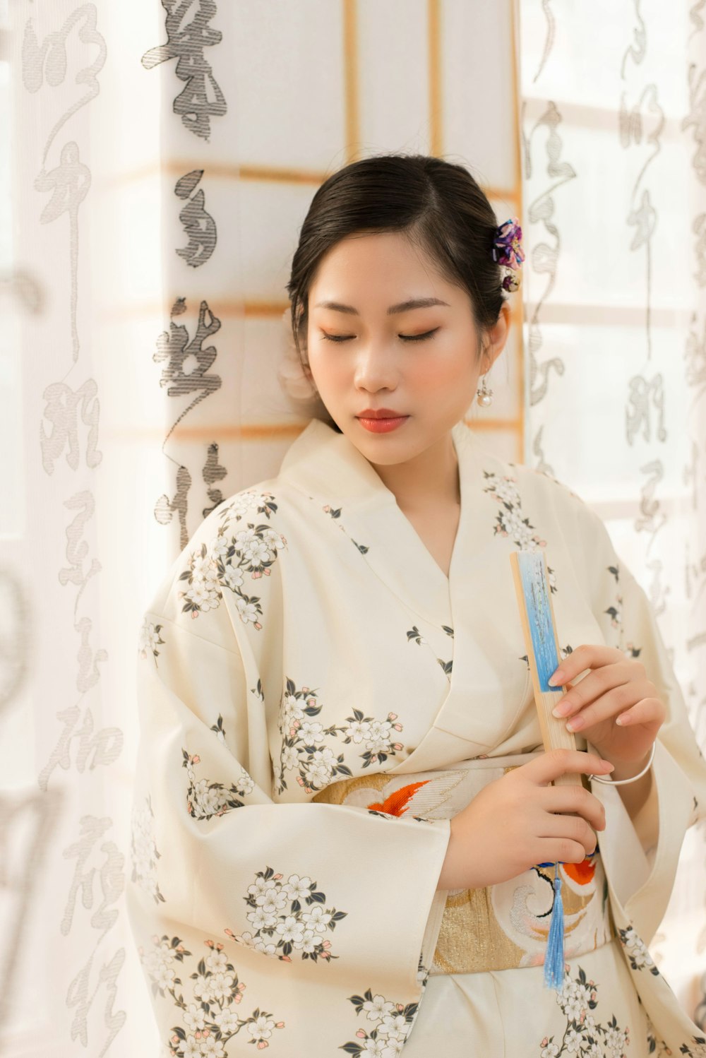 a woman in a kimono holding a comb