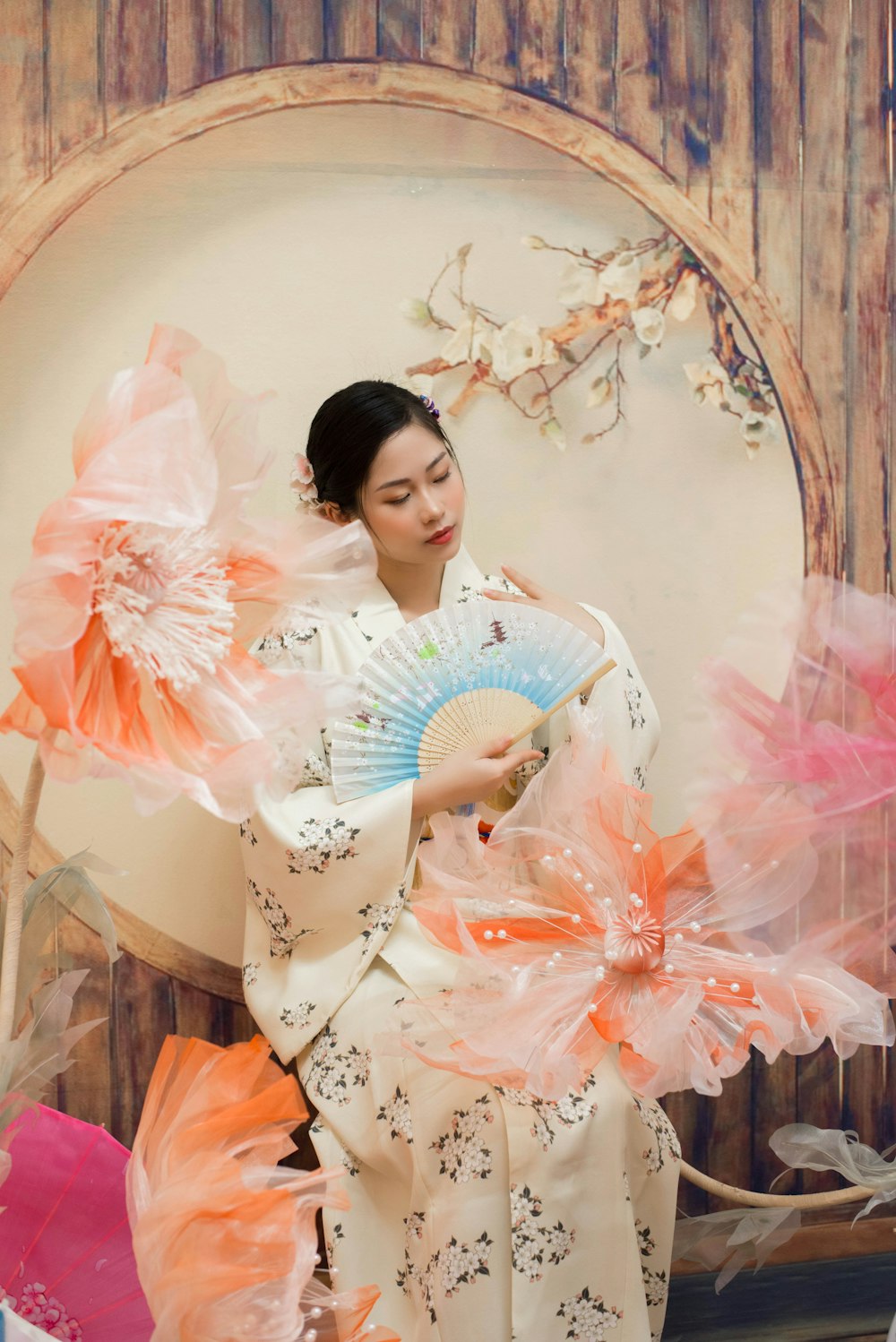 a woman in a kimono holding a fan