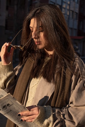 Fashionable woman wearing a chic outfit in soft natural light.
