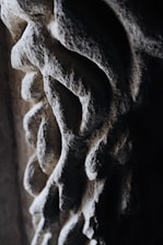 Close-up of a beautifully hand-carved stone sink with natural textures and smooth finish.