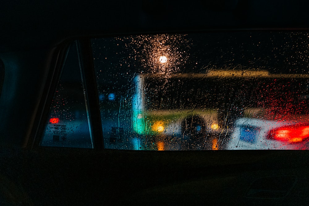 a car's rear view mirror with rain drops on it