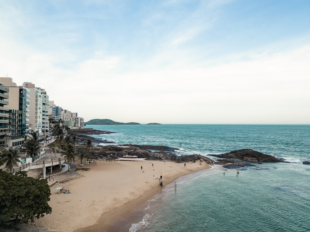 a beach with a few people walking on it