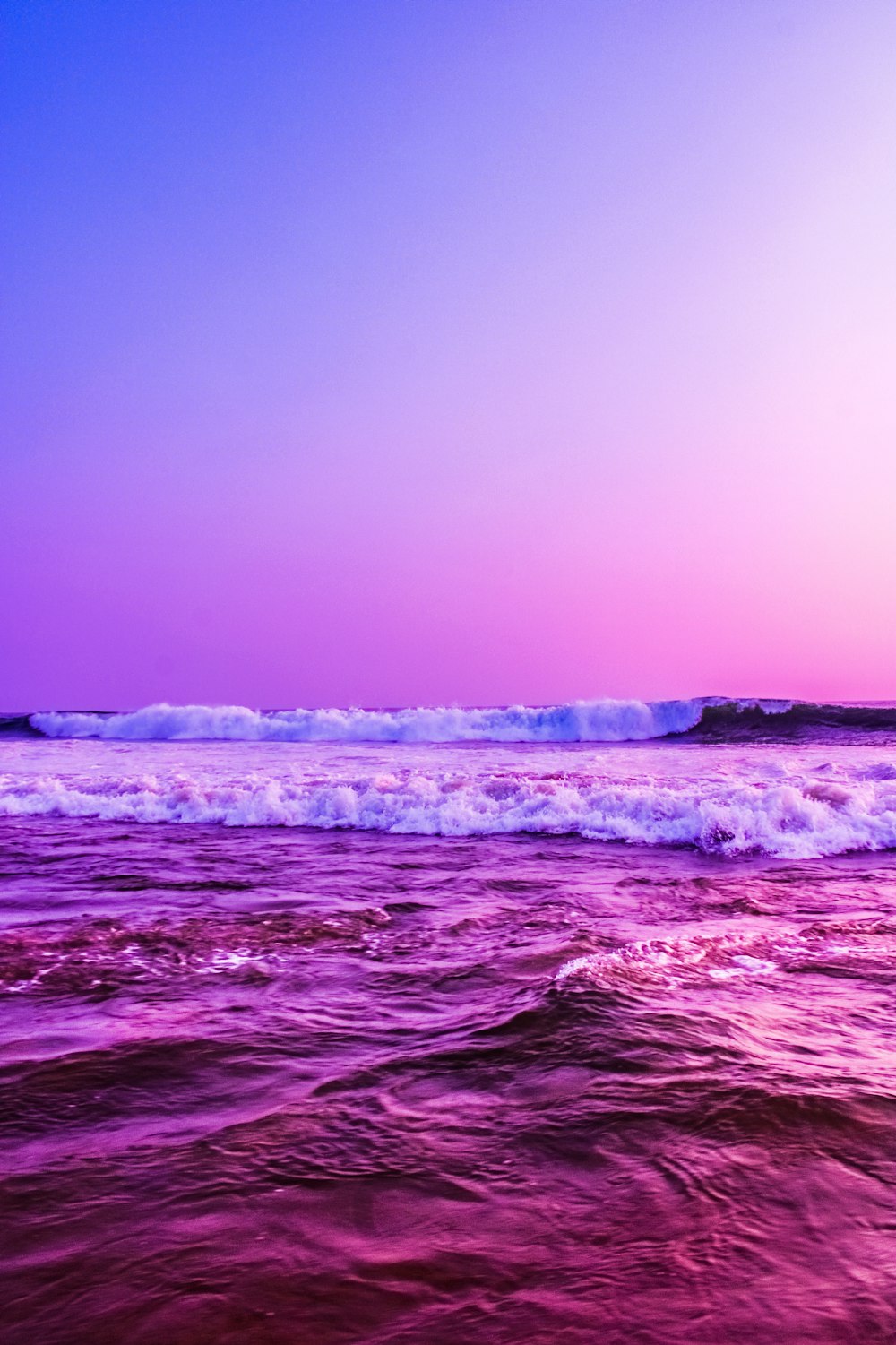 a purple and blue sky over a body of water