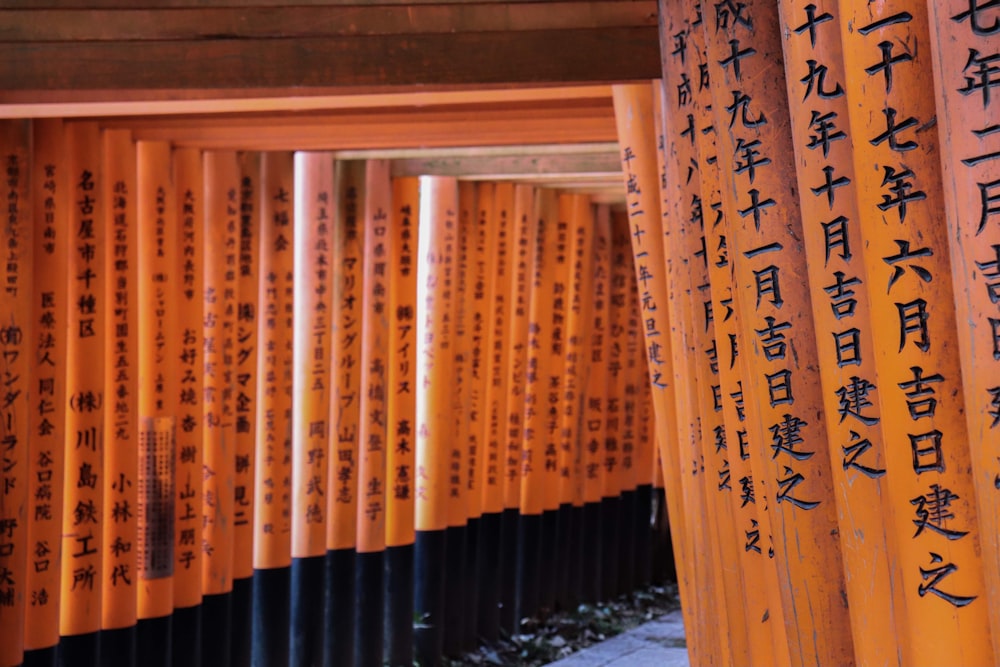 a row of orange and black columns with writing on them