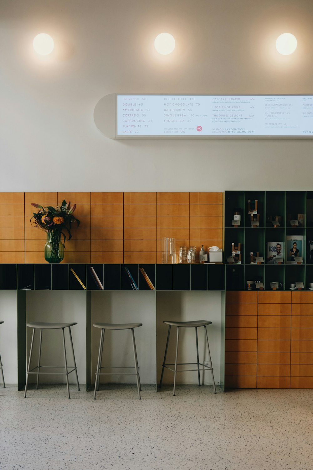 a bar with three stools in front of it