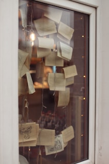 An elegant display of hand-painted book covers and artistic prints under soft lighting