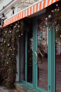 Close-up of a storefront entrance with modern door handles and welcoming decor.