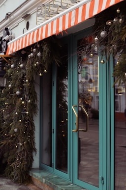 A welcoming community center entrance with colorful buttons, balls, and bows decorations.