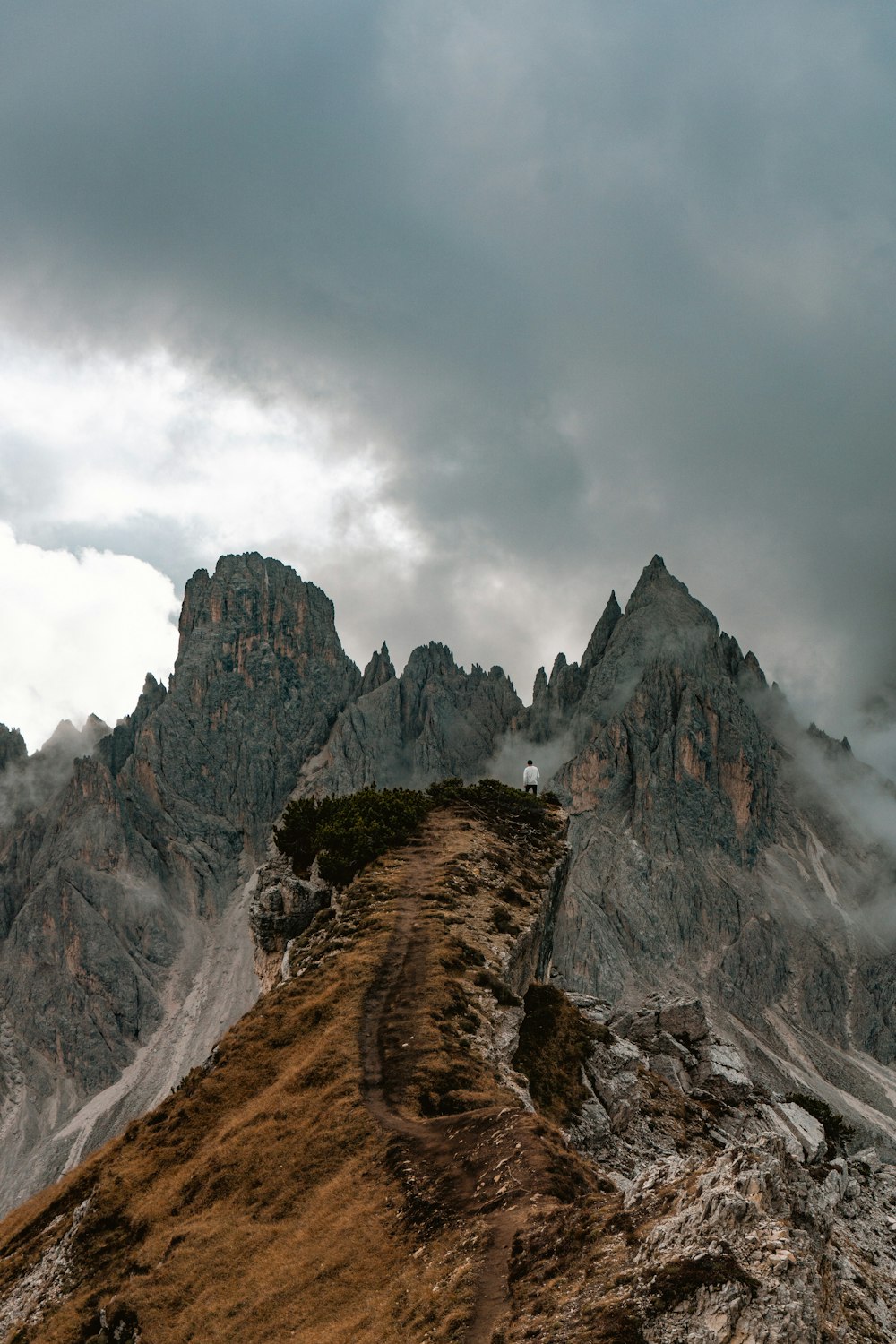 a very tall mountain with some clouds in the sky