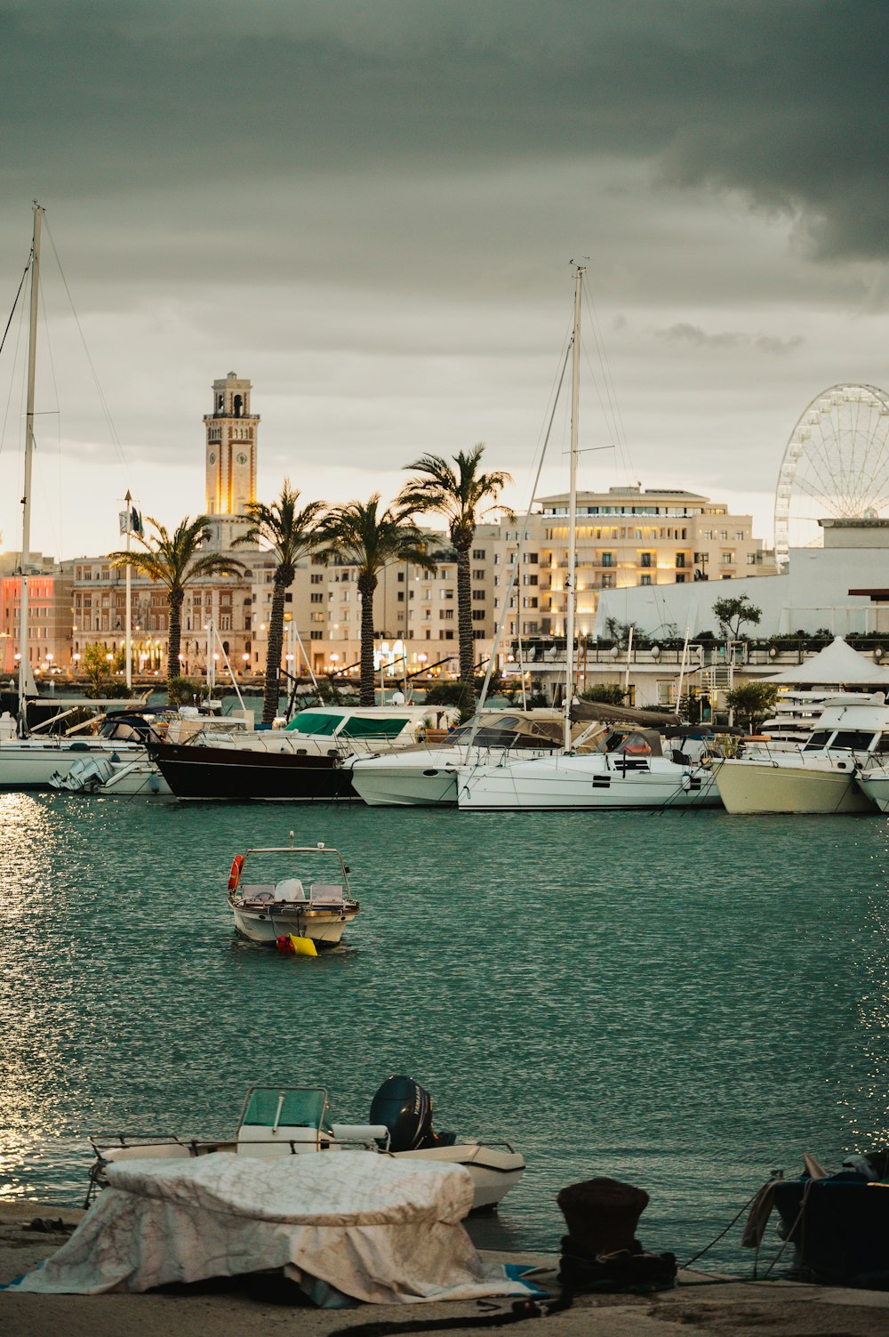 a harbor filled with lots of boats under a cloudy sky