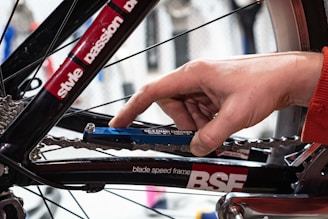 a person holding a bike chain with their hand