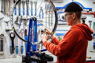 a man working on a bicycle in a bike shop