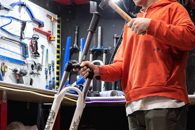 a man holding a hammer in a garage