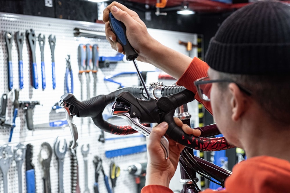 a man working on a bicycle in a bike shop