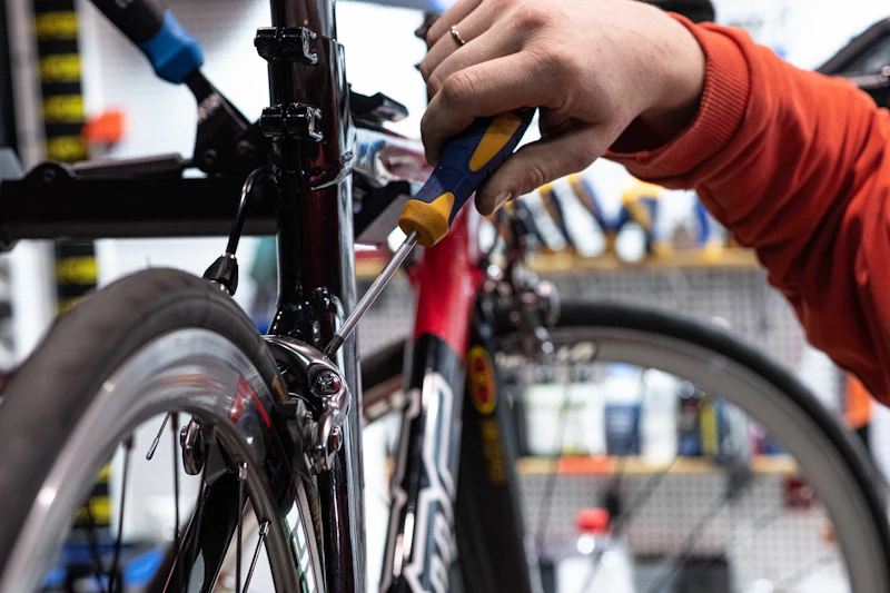 Person working on a bike inside a bike shop