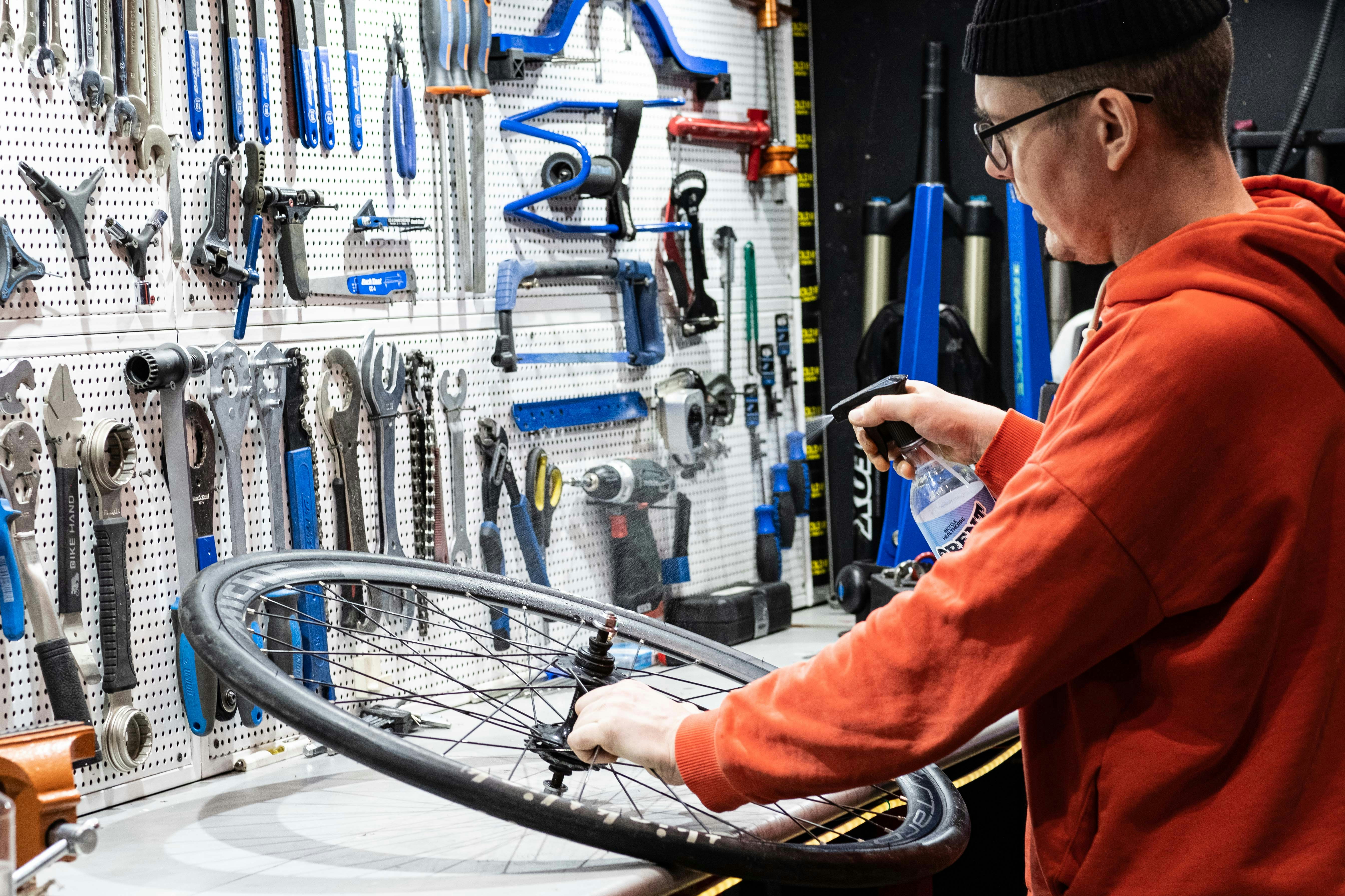 A man working on a bicycle in a bike shop
