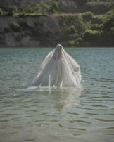 An ethereal portrait of a lovely figure suspended in a swirl of soft watercolor hues.