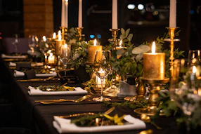 A beautifully set dining table with elegant silverware and soft candlelight ambiance.