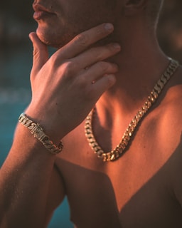 a man wearing a gold chain around his neck