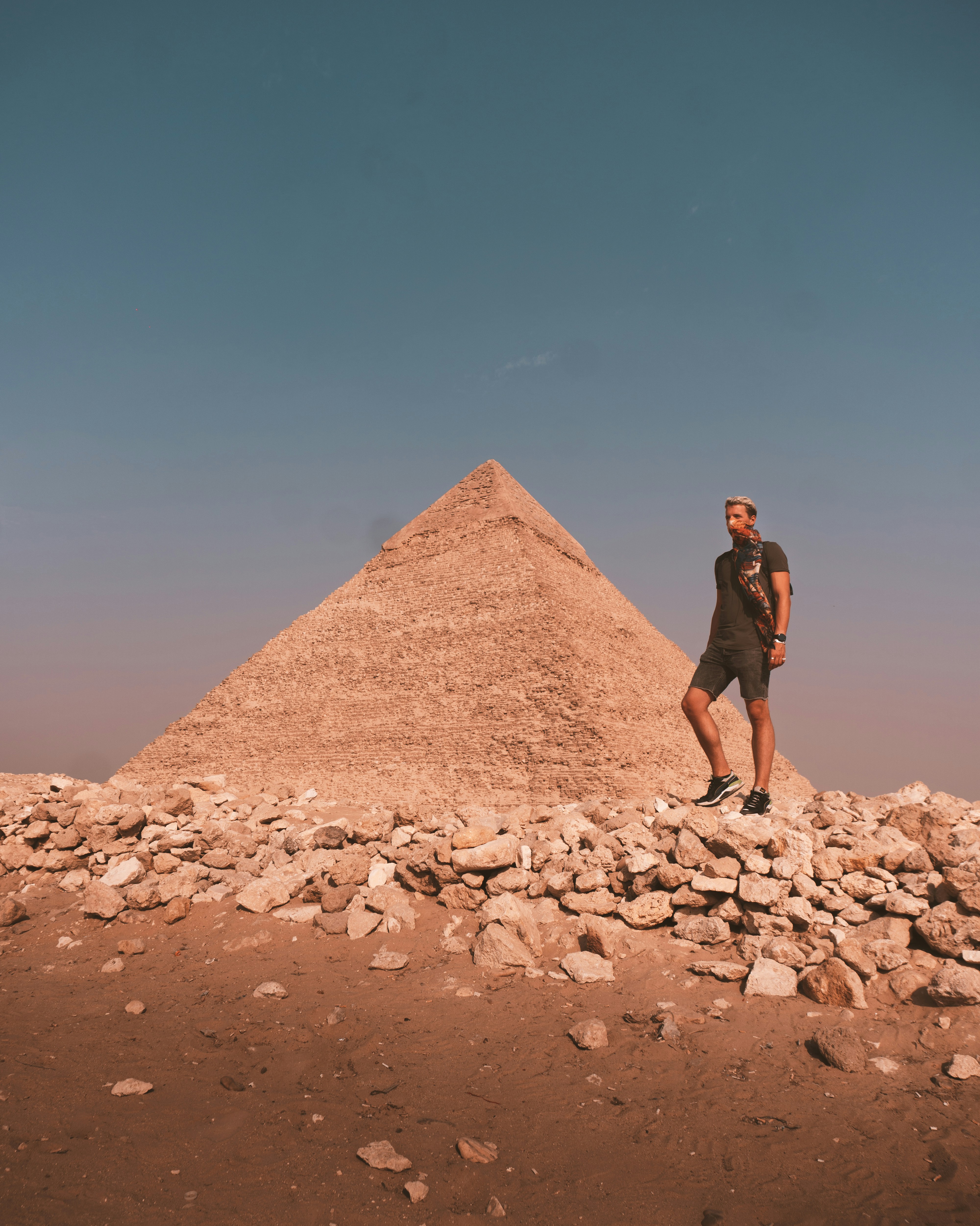 a man standing on top of a pile of rocks