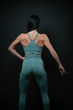 a woman in a green sports bra top and leggings