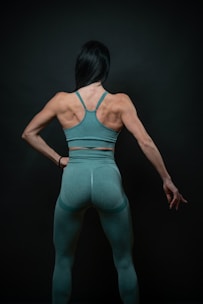 a woman in a green sports bra top and leggings
