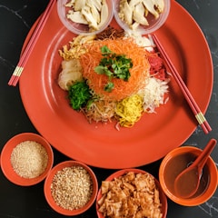 a plate of food with chopsticks and bowls of food