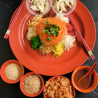 a plate of food with chopsticks and bowls of food