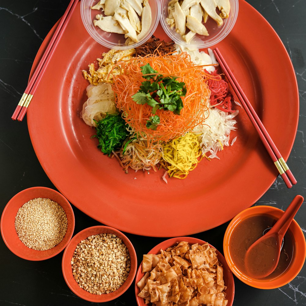 a plate of food with chopsticks and bowls of food