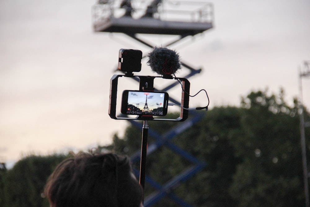 a person taking a picture of a statue with a cell phone