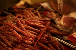 An assortment of sausages hanging in a rustic butcher shop.