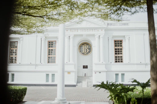 An elegant website layout featuring a prestigious private school campus with metallic gold highlights.