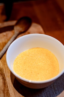 a bowl of soup on a cutting board with a spoon