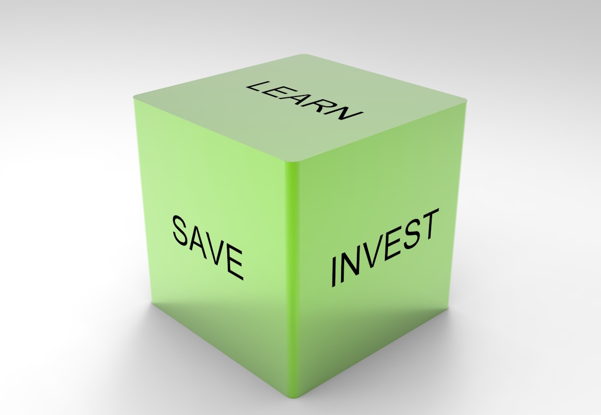 A green 3D cube with the words 'LEARN', 'SAVE', and 'INVEST' on its visible sides, set against a plain white background.