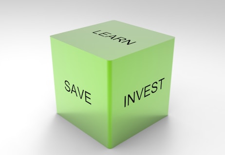 A green 3D cube with the words 'LEARN', 'SAVE', and 'INVEST' on its visible sides, set against a plain white background.
