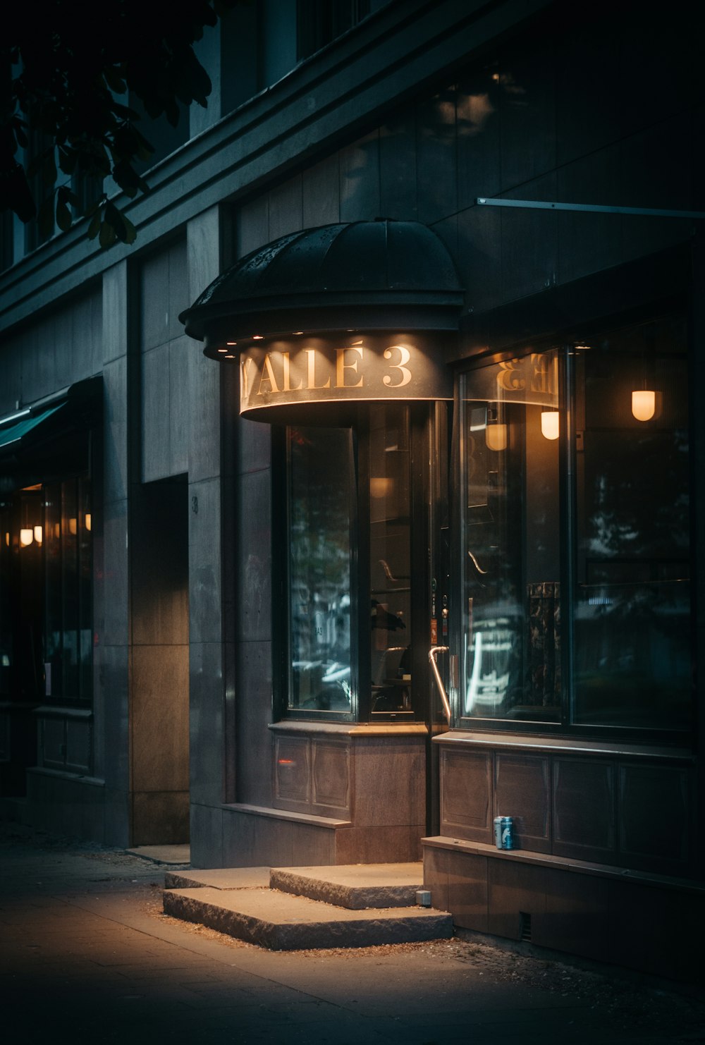 a dark street corner with a store front