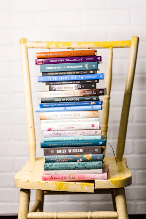 A warm, inviting workspace with open faith-based books and colorful educational materials spread out.