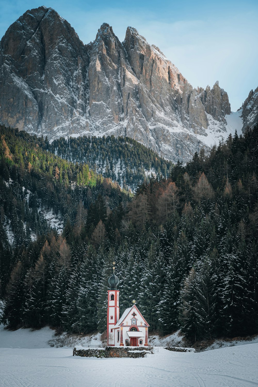 a church in the middle of a snowy field