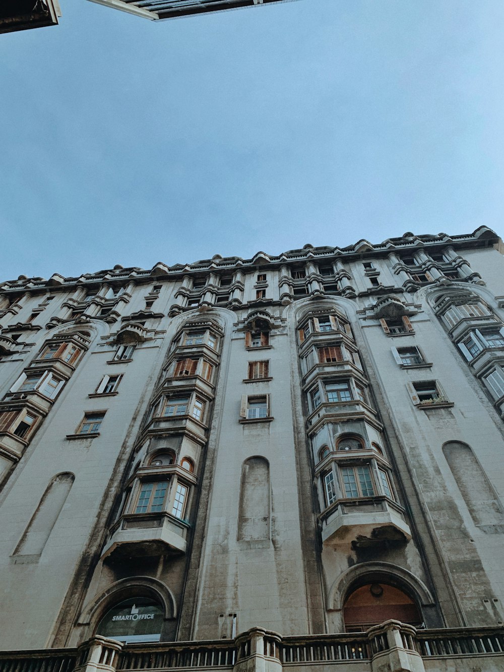 a tall building with lots of windows and balconies