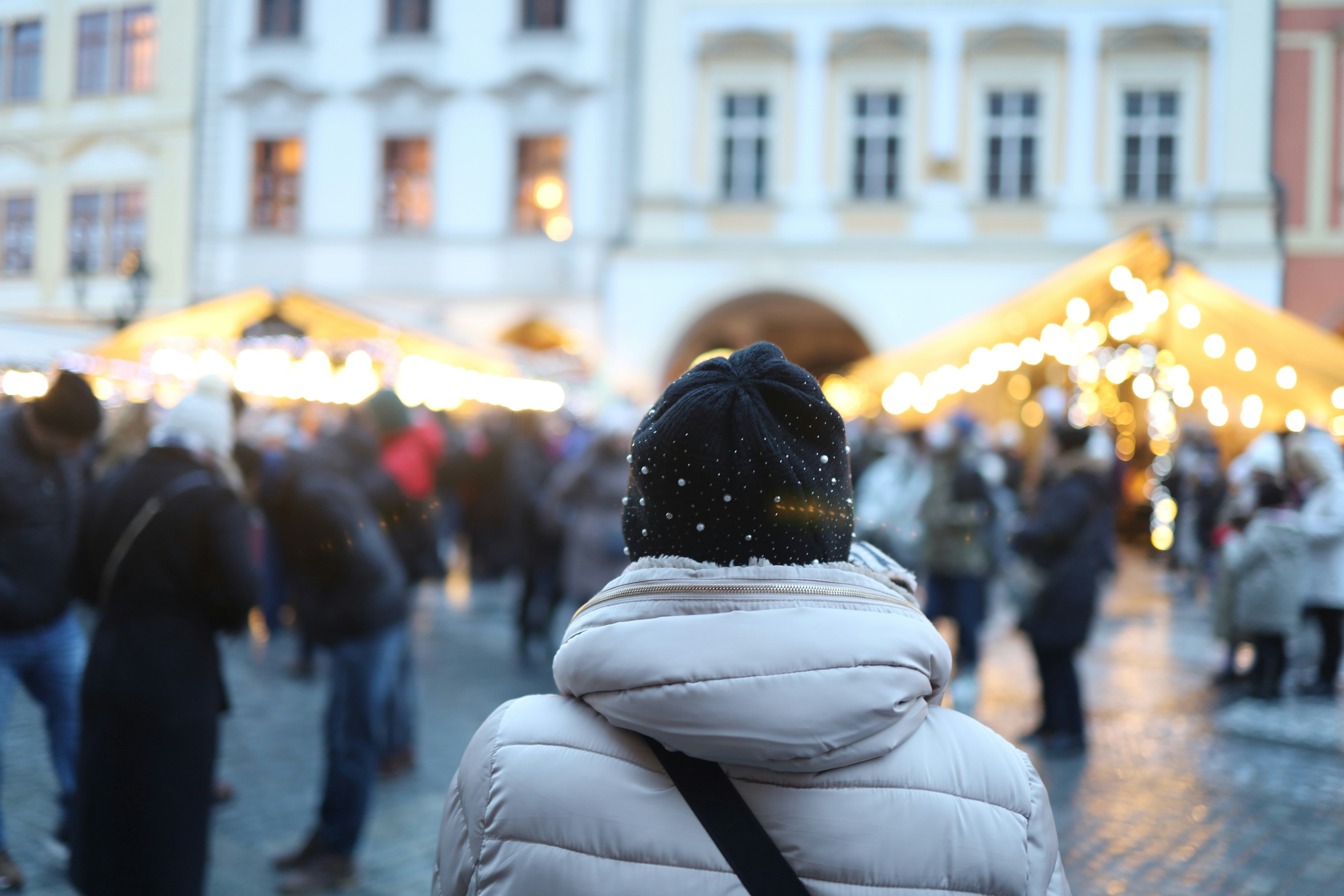 a crowd of people walking down a street next to a building